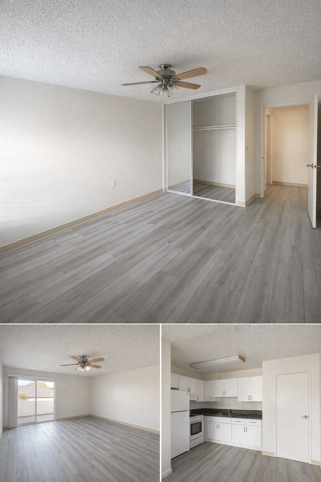 A room with a ceiling fan and a kitchen area with white cabinets.